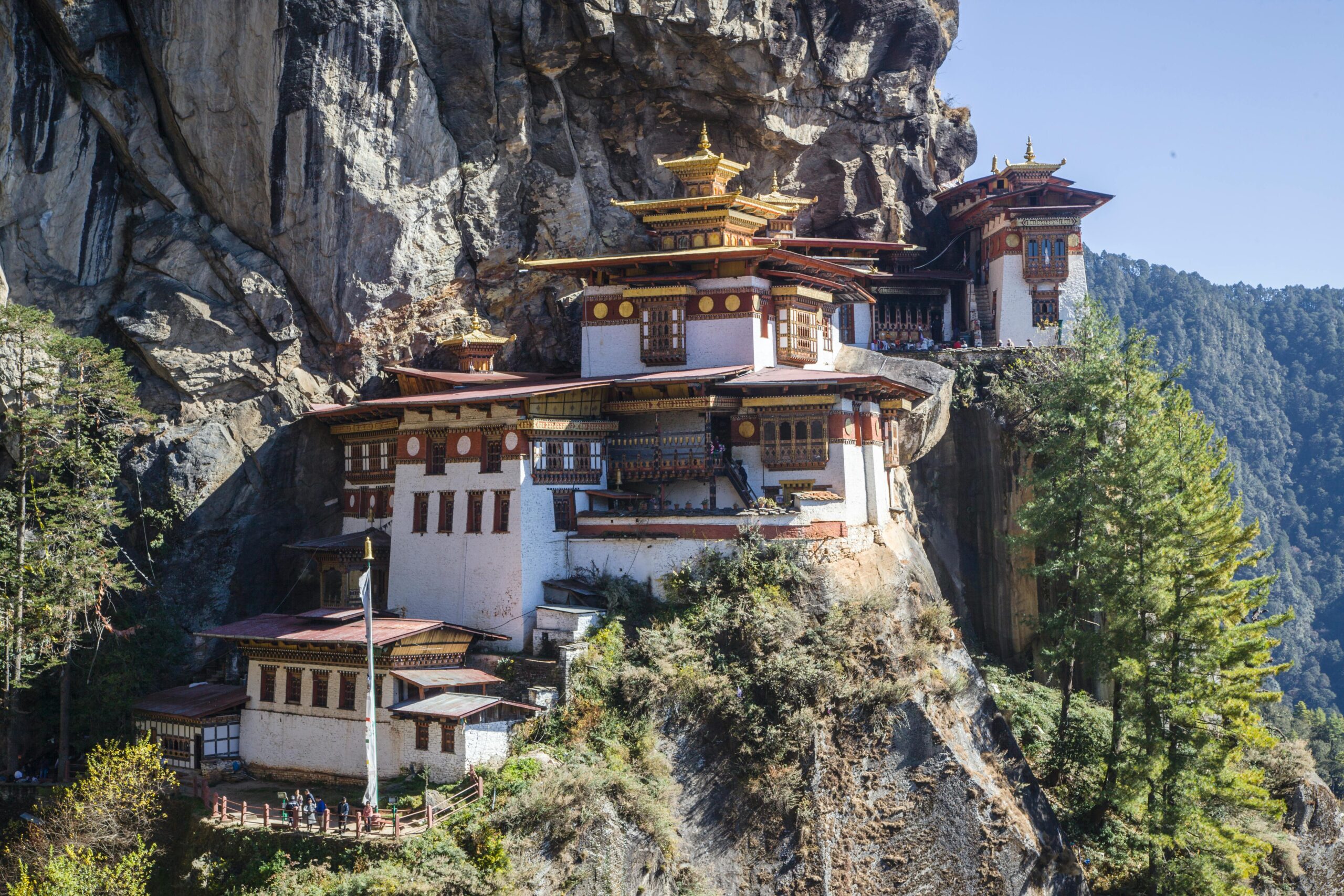 Stunning view of Tiger's Nest Monastery perched on a cliff in Bhutan's mountains.